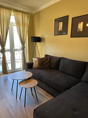 a living room with a couch and a table at Chernomorets Apartment in Chernomorets