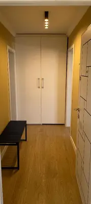 an empty room with two white doors and a table at Chernomorets Apartment in Chernomorets
