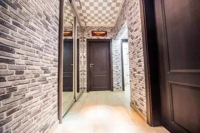a hallway with a brick wall and a door at Tsarigradska in Burgas City