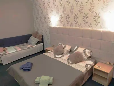 two beds in a room with towels on them at Sunrise Studio Grenada in Sunny Beach