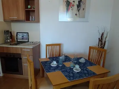 a kitchen with a table and a table and chairs at Holidays apartment Kassandra Sunny Beach in Sunny Beach