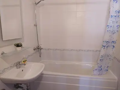 a white bathroom with a sink and a tub and a sink at Holidays apartment Kassandra Sunny Beach in Sunny Beach