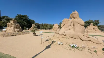a large sand sculpture of people in a park at Brisa Apartment in Burgas City