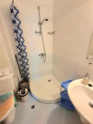a bathroom with a shower and a toilet and a sink at Sunset Dream Polo Resort in Sunny Beach