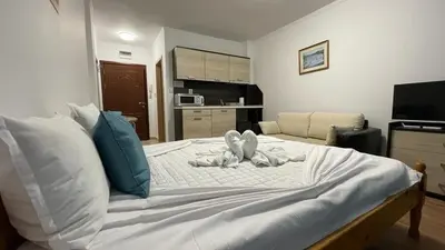 a bedroom with a large bed with towels on it at SUMMER BREEZE 503 Private Studio SUNNY BEACH in Sunny Beach
