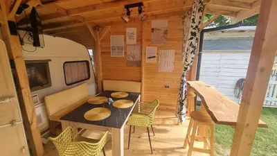 an rv with a table and chairs in a room at Каравана Амалтея in Sozopol