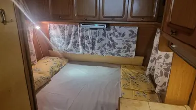 a small bed in the back of a trailer at Каравана Амалтея in Sozopol