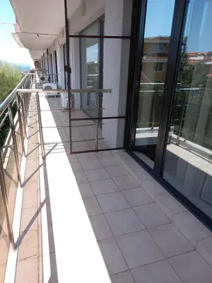 a balcony of a building with glass windows at Sozopoly studio in Sozopol