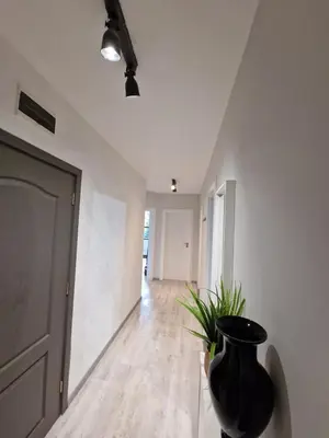 a black vase sitting in the middle of a hallway at Marsselis Luxe Port Apartment in Varna City