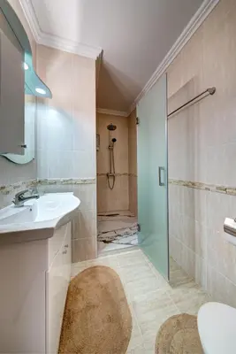 a bathroom with a sink and a shower at Luxe Apartment Olymp in Sveti Vlas in Sveti Vlas