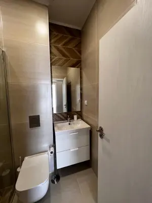a bathroom with a toilet and a sink at Las Brisas Garden Apartment in Burgas City