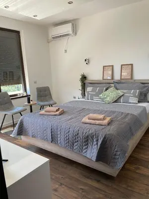 a bedroom with a large bed with two towels on it at Studio Rêve in Burgas City