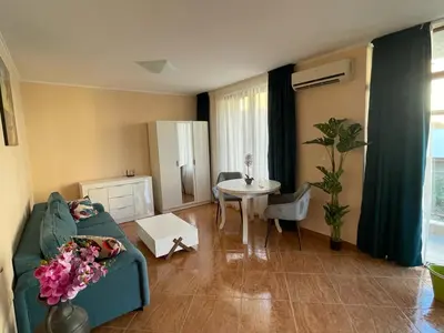 a living room with a couch and a table at HELIOS I premium in Sveti Vlas