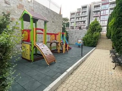 a playground with a slide and a play structure at HELIOS I premium in Sveti Vlas