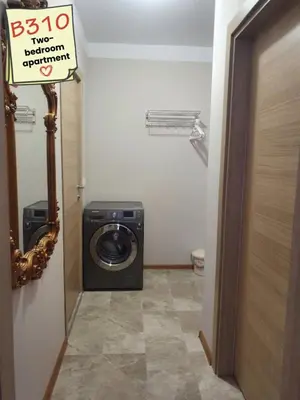 a washer and dryer in a bathroom with a sign at Apartments Vilma&Villiam in Ravda