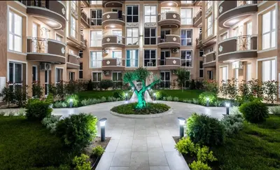 an apartment building with a statue in the courtyard at Apartments Vilma&Villiam in Ravda