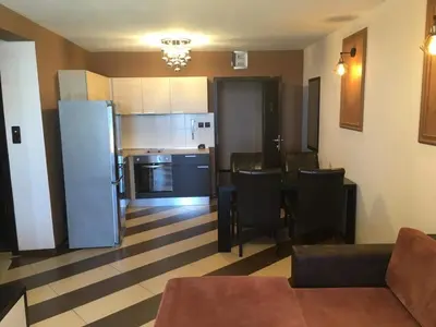 a kitchen and living room with a refrigerator and a table at Heaven Lux Apartments in Sunny Beach