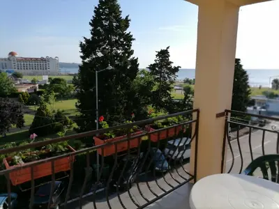 a balcony with plants and a view of a city at Ivet Guest Rooms - Obzor in Obzor