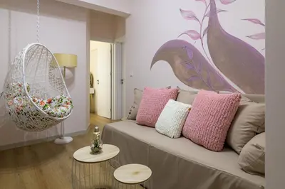 a living room with a couch with pink pillows at Black Sea Dolphin Apartment in Varna City