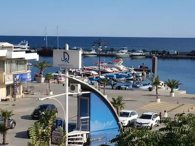 a marina with cars parked in a parking lot at Sveti Vlas Marina Beach Apartment - Vega Village in Sveti Vlas