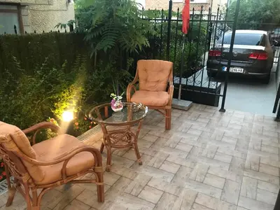 a patio with chairs and a table and a fence at Sunrise City A1, Sarafovo in Burgas City