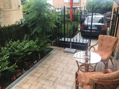 a patio with a table and chairs and a fence at Sunrise City A1, Sarafovo in Burgas City