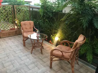 a patio with two chairs and a table and a fence at Sunrise City A1, Sarafovo in Burgas City