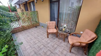 an outdoor patio with two chairs and a table at Sunrise City A2, Sarafovo in Burgas City