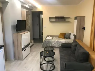 a small living room with a couch and a bed at Sunrise City A2, Sarafovo in Burgas City