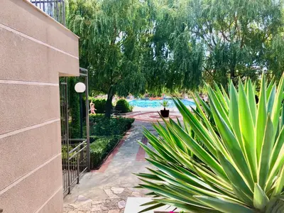 a garden with a fence and some plants at Sorrento - Menada Apartments in Sveti Vlas