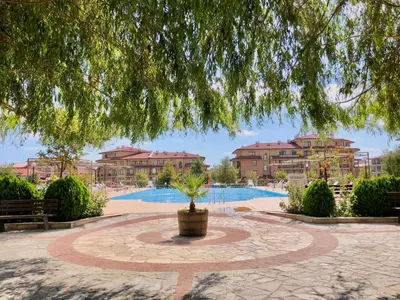 a fountain in the middle of a courtyard with a resort at Sorrento - Menada Apartments in Sveti Vlas