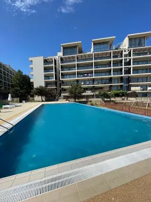 a large swimming pool in front of a building at YooBulgaria-Obzor SP apartments in Obzor