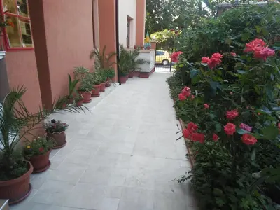 a corridor of a building with flowers and plants at Kostovi Primorsko in Primorsko