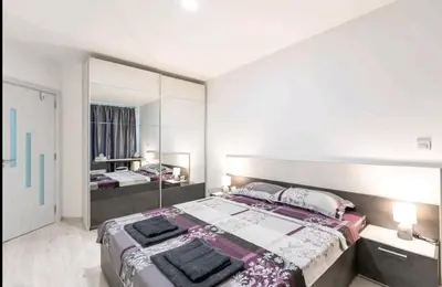 a bedroom with a large bed and a large mirror at LOVE apartment in Burgas City