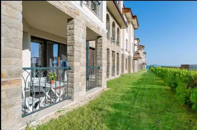 a building with a balcony with a view of the ocean at LOVE apartment in Burgas City