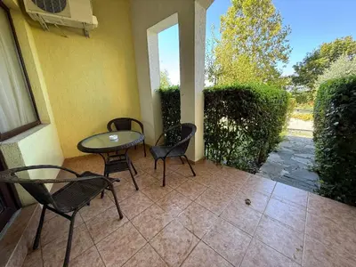 a patio with chairs and a table and a window at Marina Cape SP private apartments in Aheloy