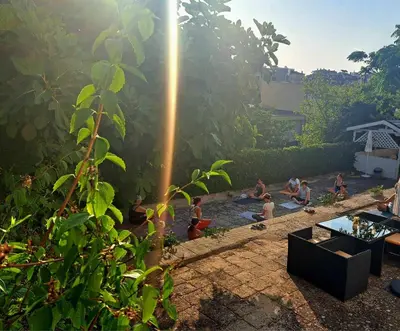 a group of people bathing in a pool in a garden at Effect Saint Mina in Sozopol