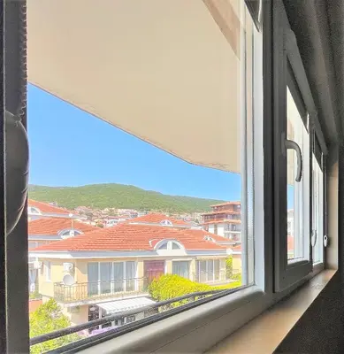 a window with a view of a building at Cozy 1BD Apartment with a Lovely Sea View by Flat Mаnаger in Sveti Vlas