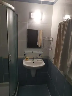 a bathroom with a sink and a mirror and a shower at Sveti Vlas Kambani Bells 3 Ap 7a in Sveti Vlas