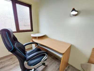 a desk and a chair in a room at Апартаменти за гости Делукс in Burgas City