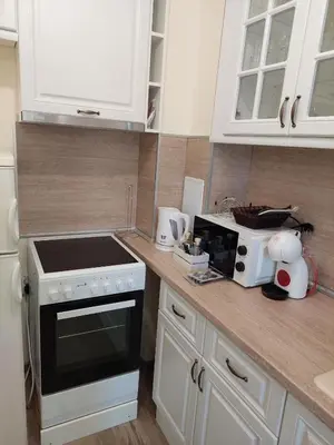 a kitchen with a counter with a stove and a microwave at Апартаменти за гости Делукс in Burgas City