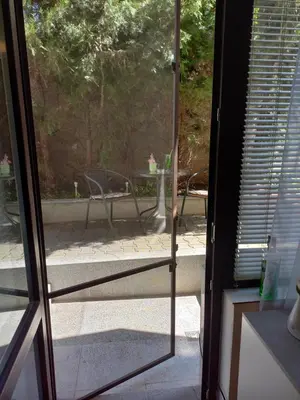 an open glass door with a view of a patio at Венета 1 in Sozopol
