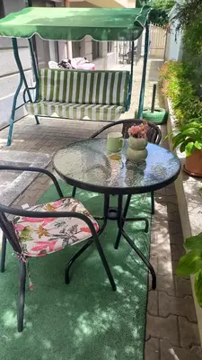 a table and a chair and a bench on a patio at Венета 1 in Sozopol
