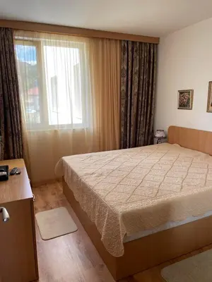 a bedroom with a large bed and a window at Atlantik-Byala SP apartments in Byala