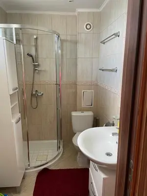 a bathroom with a shower and a toilet and a sink at Atlantik-Byala SP apartments in Byala