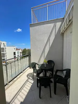 a patio with a table and chairs on a balcony at Atlantik-Byala SP apartments in Byala