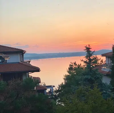 a view of a lake at sunset with houses at AJ Apartment 1 with Pool view, Santa Marina Holiday Village, Sozopol in Sozopol