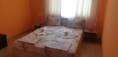 a bed in a room with a window at Къща за гости Симеонови in Sozopol