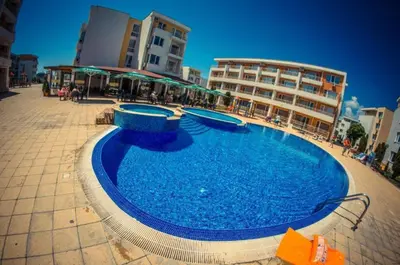 a large swimming pool in front of a building at 1-bedroom Apartment in a Resort with 6 Pools, Top Floor, Stunning Sunset View in Sunny Beach