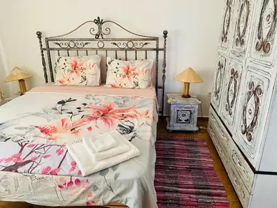 a bedroom with a large bed with flowers on it at Complex Monastery 1 -Marina Dinevi -Saint Vlas in Sveti Vlas